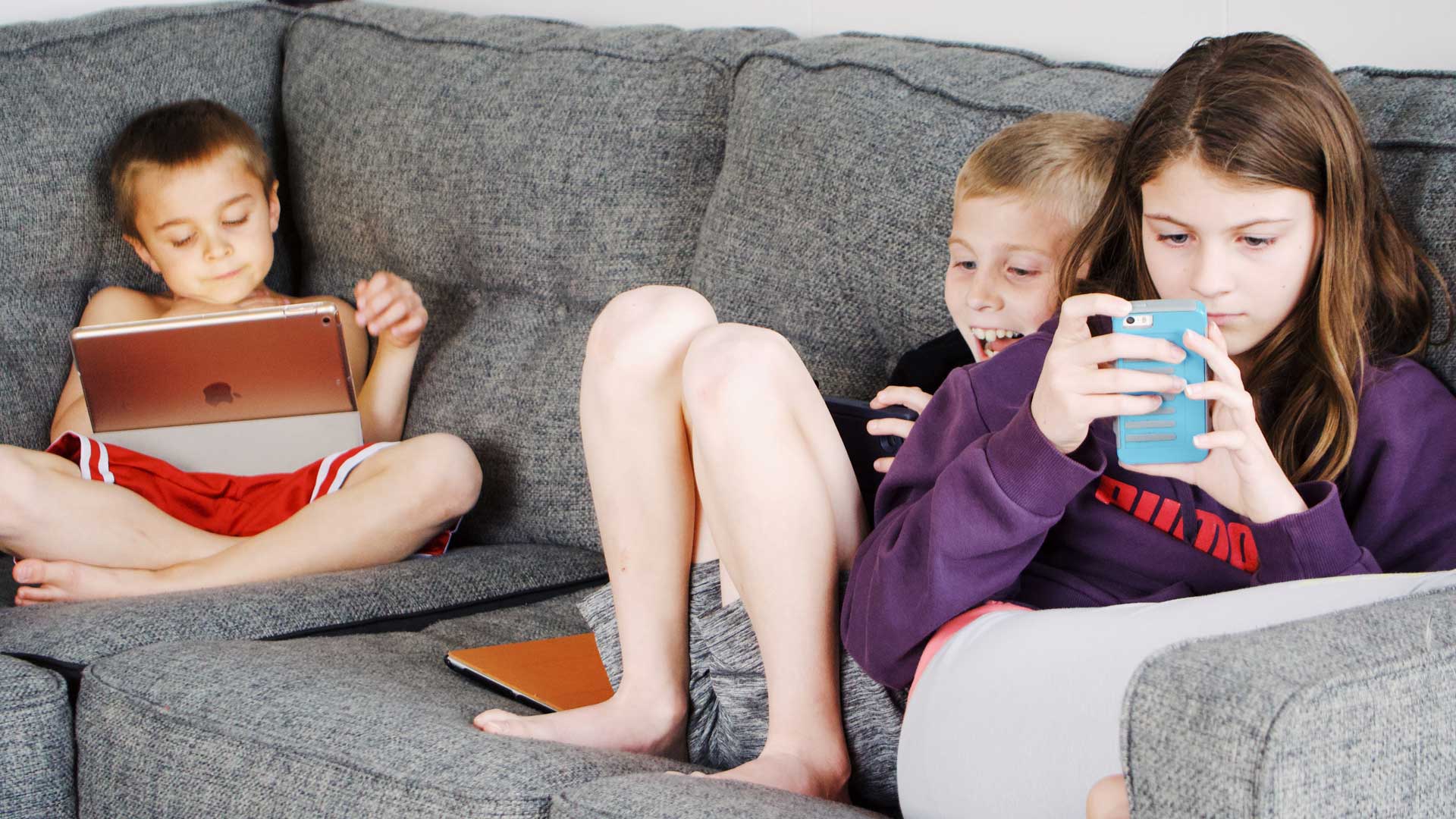 Children with mobile phones and tablets